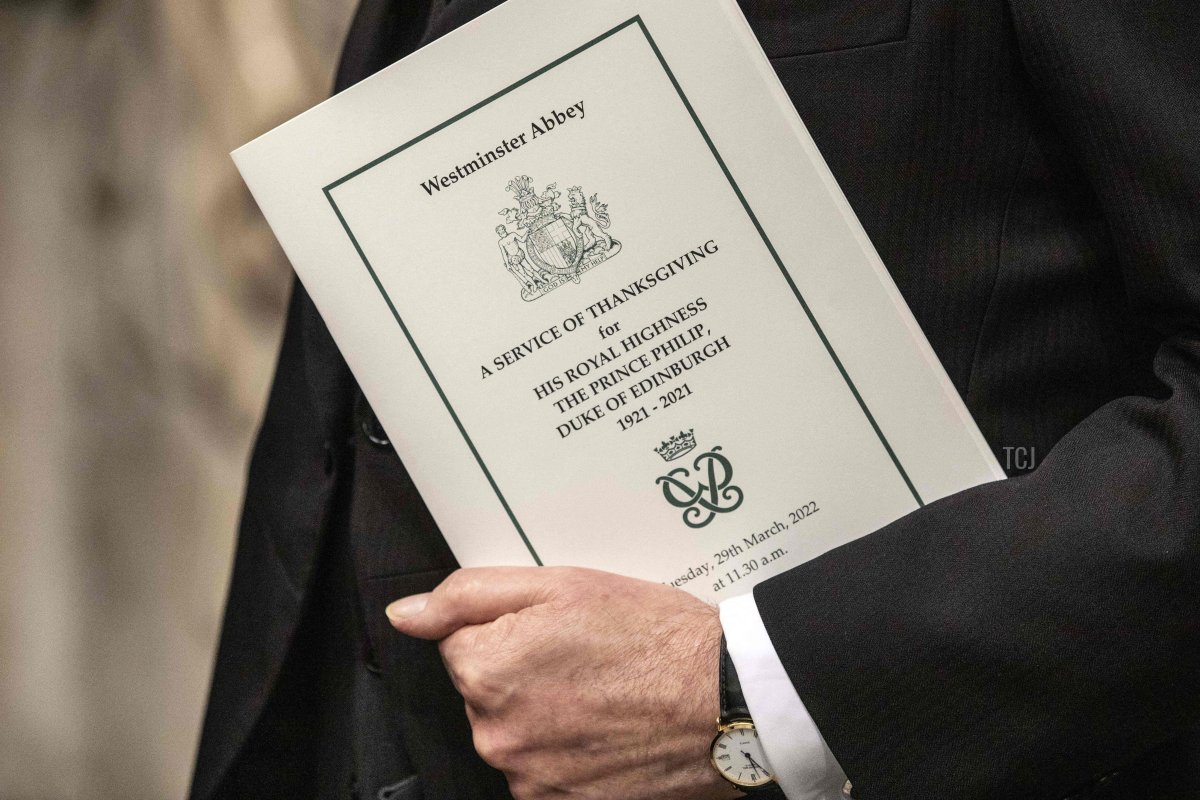 An order of service is pictured in a guest's hand during a Service of Thanksgiving for Britain's Prince Philip, Duke of Edinburgh, at Westminster Abbey in central London on March 29, 2022