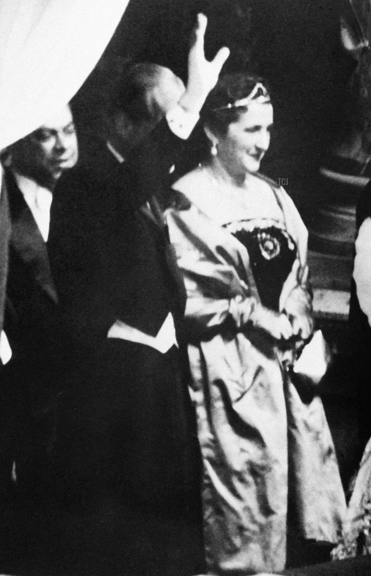 Queen Elizabeth II (R) and Duke of Edinburgh (L) flanked by French President Rene Coty and First lady Germaine Coty wave to the crowd from the balcony at the Opera Garnier in Paris during a state visit in France on April 9, 1957