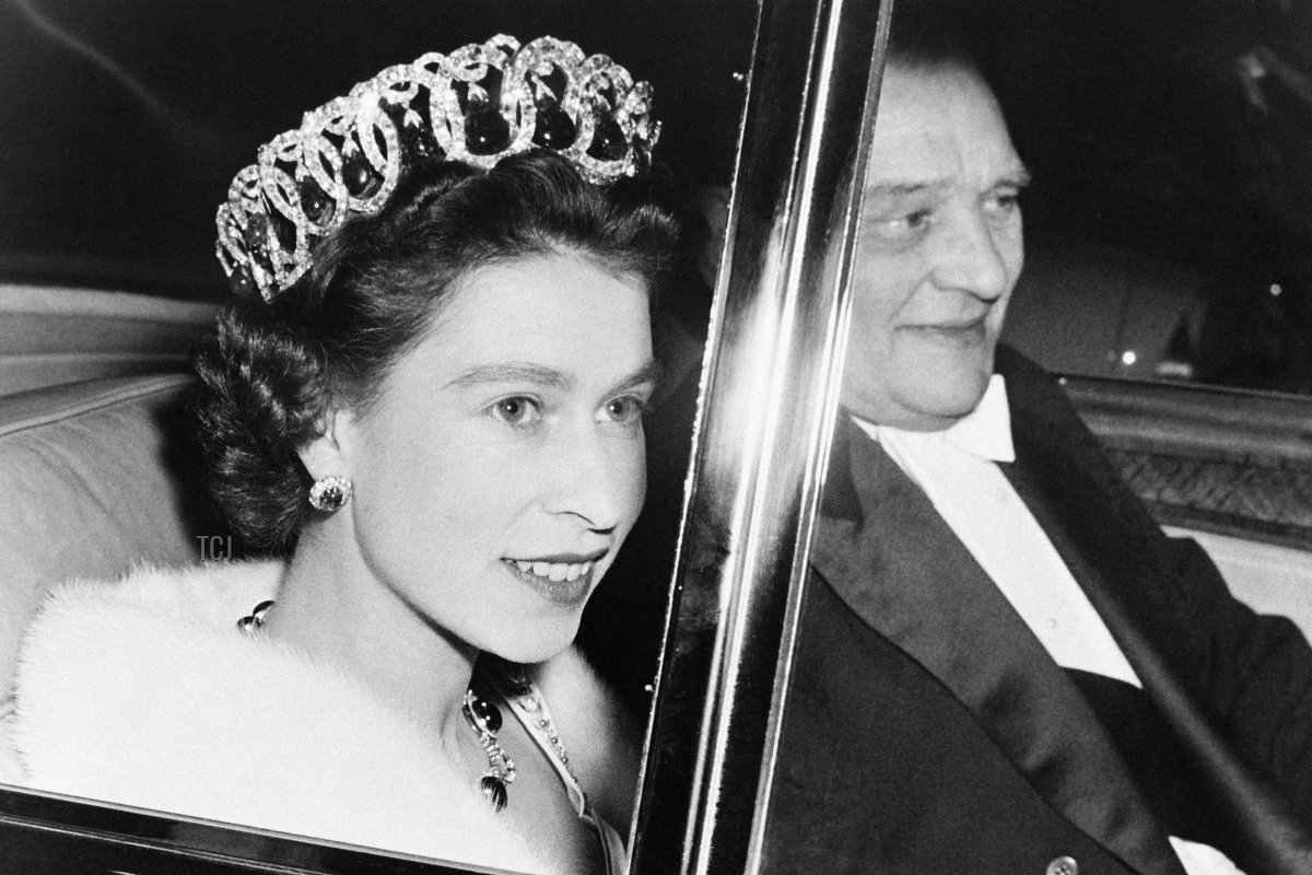 Queen Elizabeth II and French President Rene Coty are seen in a car on their way to the Opera Garnier in Paris during a state visit in France on April 9, 1957
