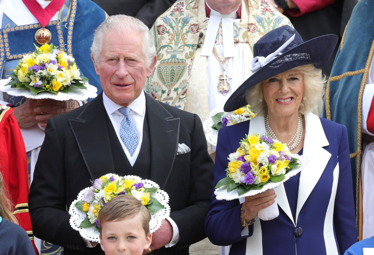 Prince Charles, Prince of Wales and Camilla, Duchess of Cornwall pose with the Queen's Bodyguard of the Yeomen of the Guard and guests as they attend the Royal Maundy Service at St George's Chapel on April 14, 2022 in Windsor, England