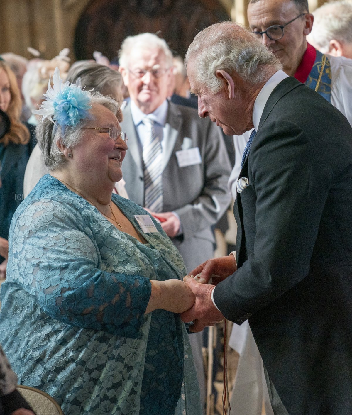 Prince Charles, Prince of Wales, meets members of the congregation as he represents Queen Elizabeth II at the Royal Maundy Service at St George's Chapel on April 14, 2022 in Windsor, England