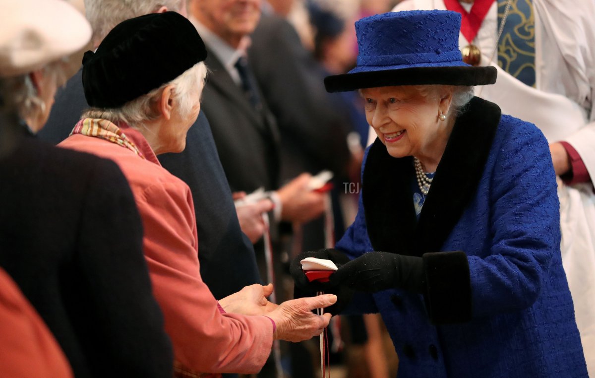 Britain's Queen Elizabeth II distributes the Maundy money during the Royal Maundy Service at St George's Chapel in Windsor, west of London on March 29, 2018