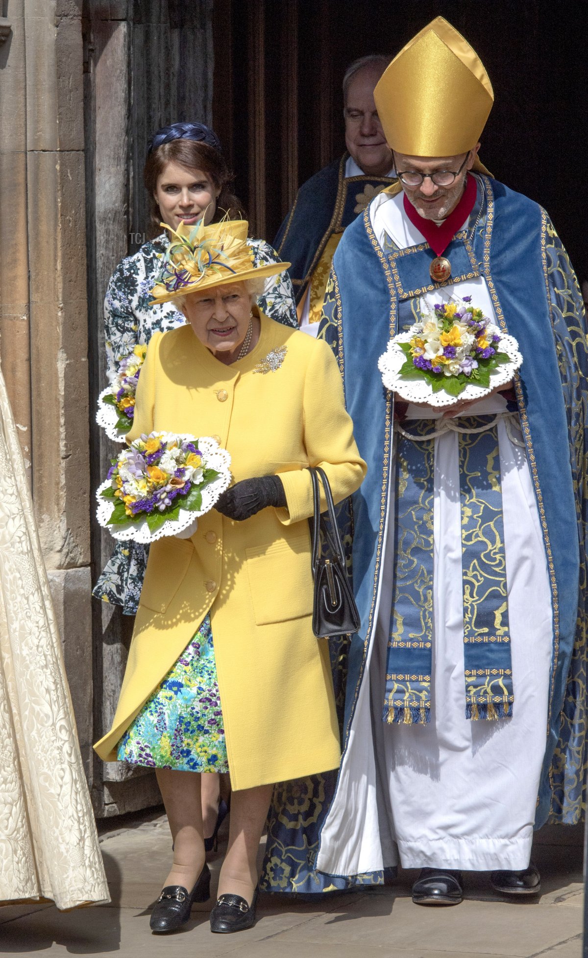 Queen Elizabeth II and the Lord High Almoner, the Right Reverend Dr. John Inge leave the traditional Royal Maundy Service at St George's Chapel on April 18, 2019 in Windsor, England