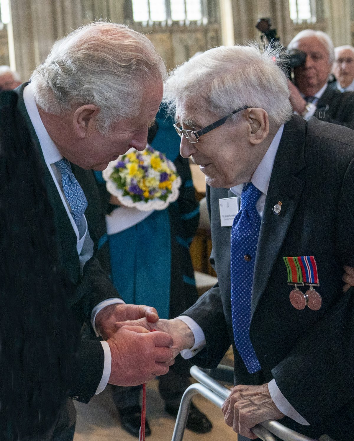 Prince Charles, Prince of Wales, meets members of the congregation as he represents Queen Elizabeth II at the Royal Maundy Service at St George's Chapel on April 14, 2022 in Windsor, England