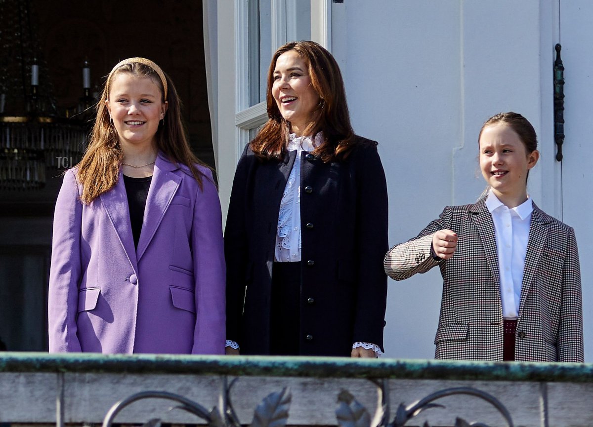 Denmark's Queen Margrethe II (C) greets well-wishers as Crown Prince Frederik (1st L), Prince Vincent (2ndL), Prince Christian (3rd L), Princess Isabella (3rd R), Crown Princess Mary (2nd R) and Princess Josephine (1st R) stand from the balcony of Marselisborg Castle in Aarhus, on April 16, 2022, on the occasion of her 82nd birthday