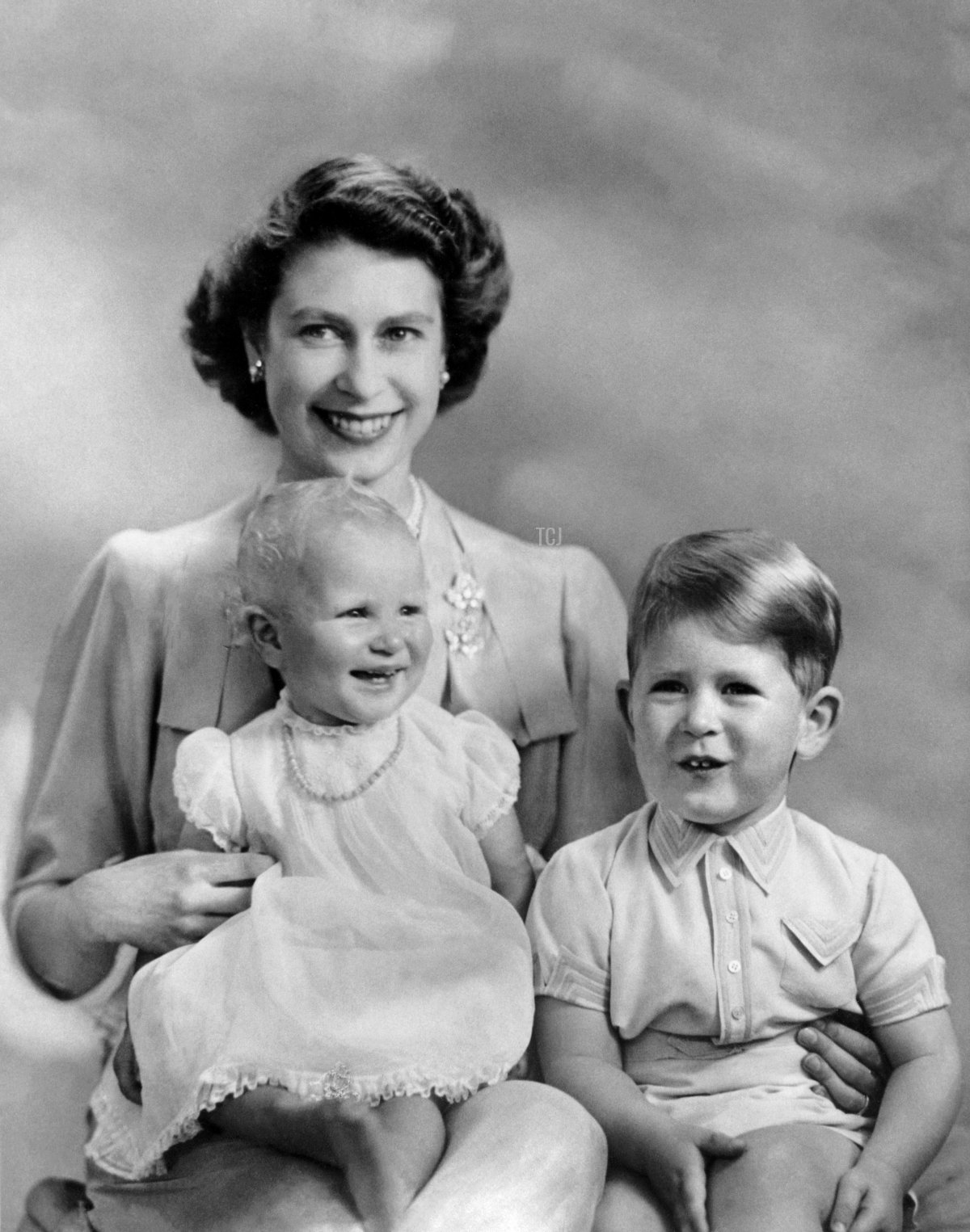 Princess Elizabeth poses with her two children, Princess Anne and Prince Charles, in 1951