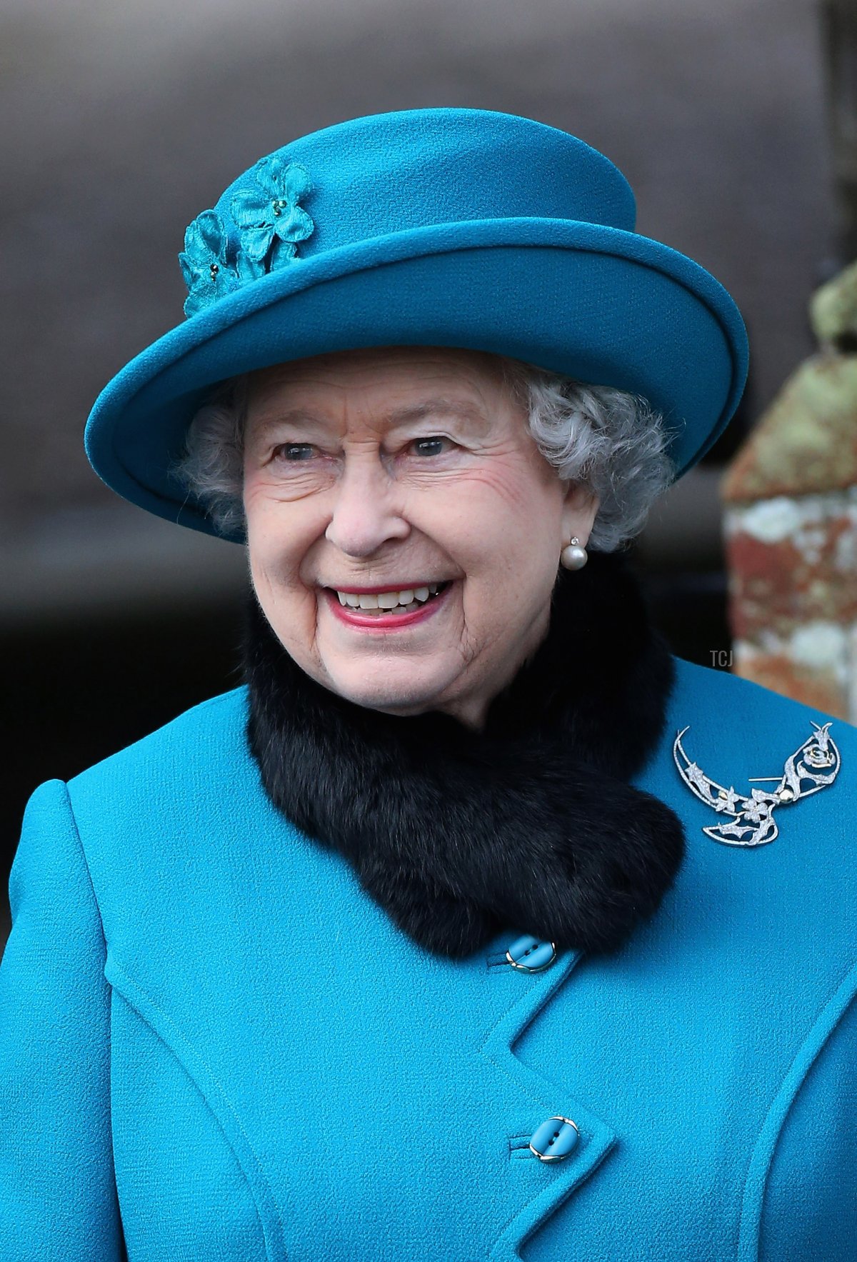 Queen Elizabeth II smiles as she leaves St Mary Magdalene Church after attending the traditional Christmas Day church service on December 25, 2012 in Sandringham, near King's Lynn, England