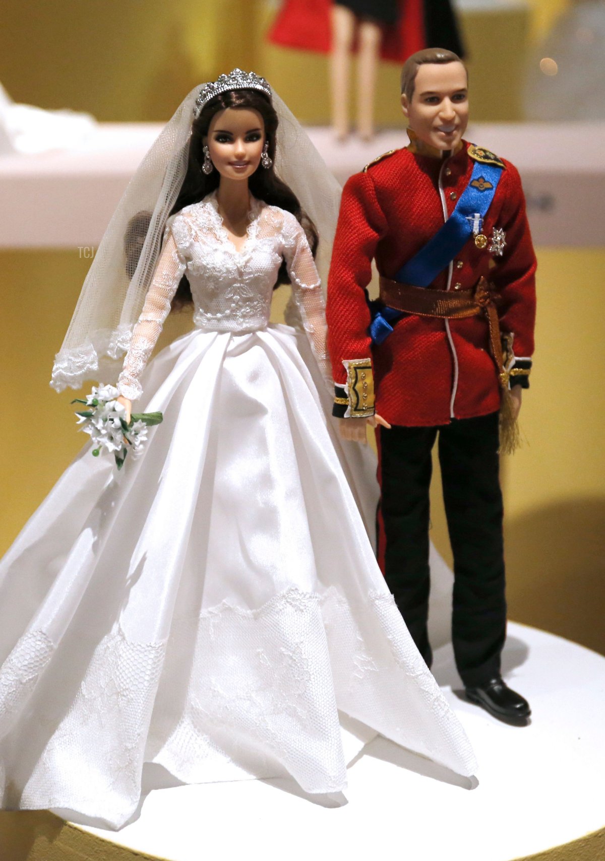 A photo taken on March 10, 2016 in Paris shows Barbie dolls representing Britain's Prince William, Duke of Cambridge (R) and Catherine Middleton Duchess of Cambridge, during the exhibition "Barbie, life of an icon" at the Museum of Decorative Arts, in Paris