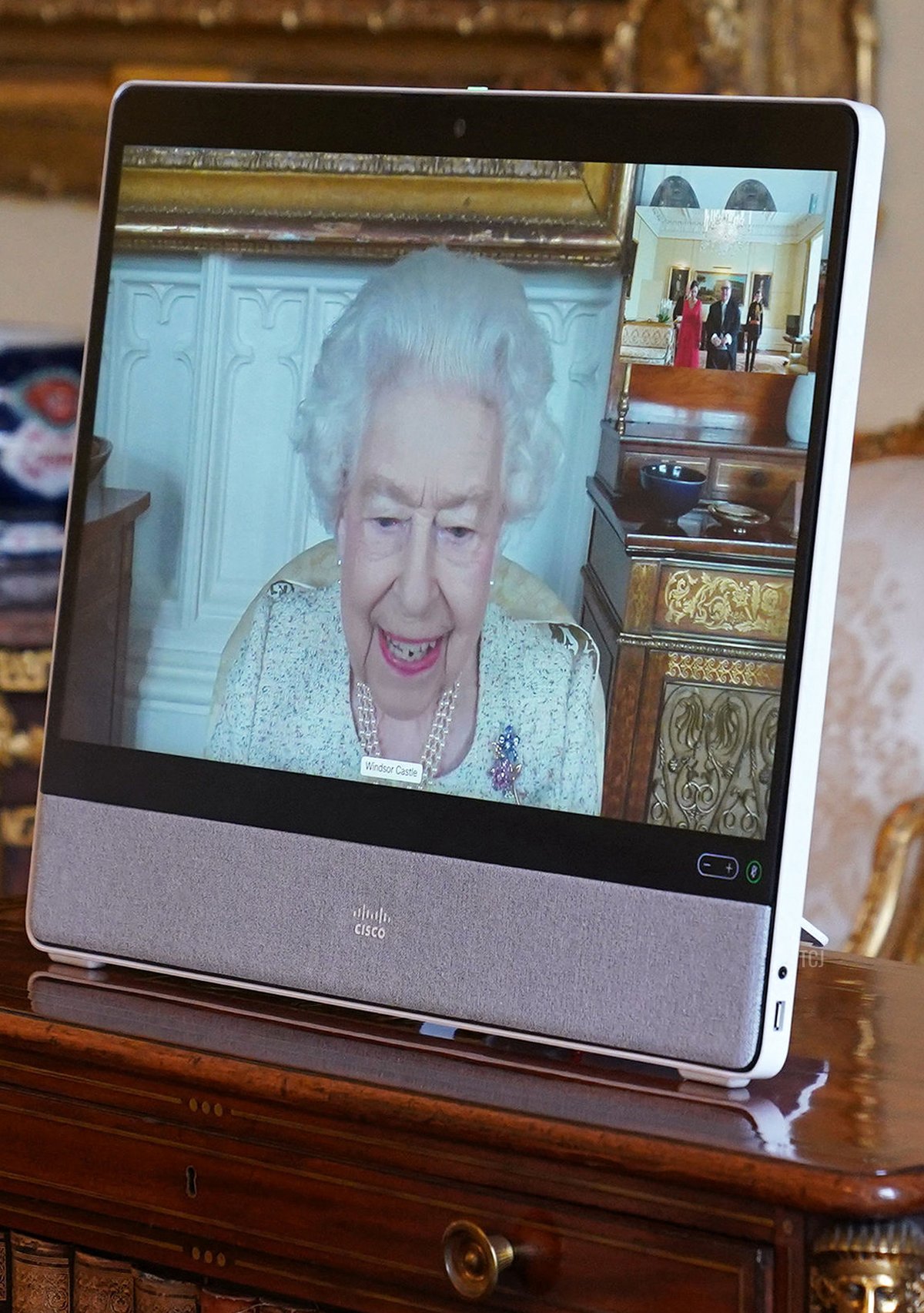 Britain's Queen Elizabeth II, in residence at Windsor Castle, appears on a screen via videolink during a virtual audience to receive Dr. Emmanuel Mallia, High Commissioner for the Republic of Malta, and his wife Elena Codruta, at Buckingham Palace in London on April 29, 2022