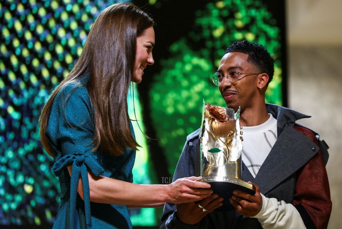 Britain's Catherine, Duchess of Cambridge (L) gives the trophy of "The Queen Elizabeth II Award for British Design" to winner British fashion designer Saul Nash during the prize ceremony at the Londons Design Museum, on May 4, 2022