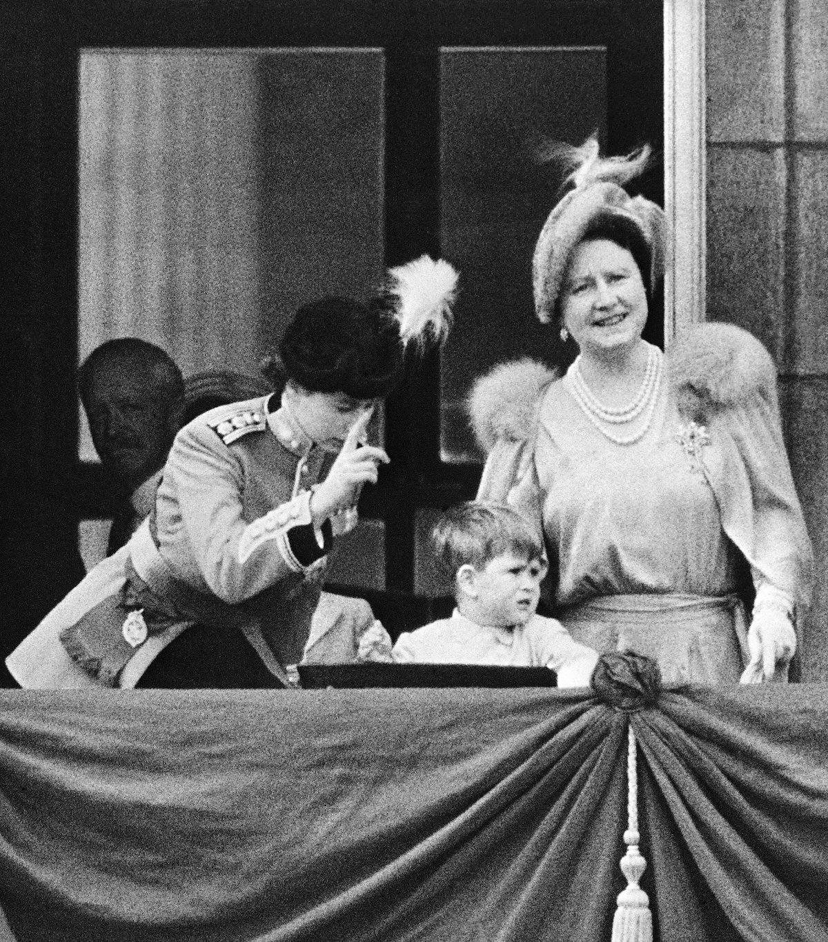 Princess Elizabeth, Prince Charles, and Queen Elizabeth are pictured on the balcony of Buckingham Palace during the Trooping the Colour celebrations on June 7, 1951 (INTERCONTINENTALE/AFP via Getty Images)
