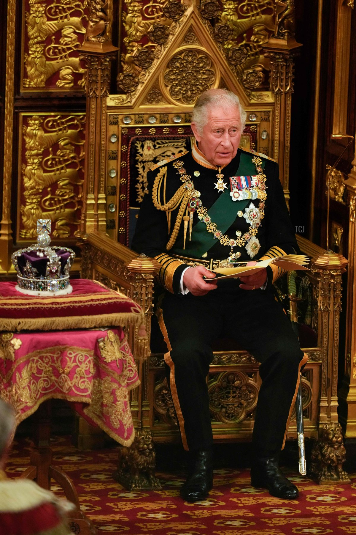 Britain's Prince Charles, Prince of Wales (R) sits by the The Imperial State Crown (L) in the House of Lords Chamber during the State Opening of Parliament at the Houses of Parliament, in London, on May 10, 2022