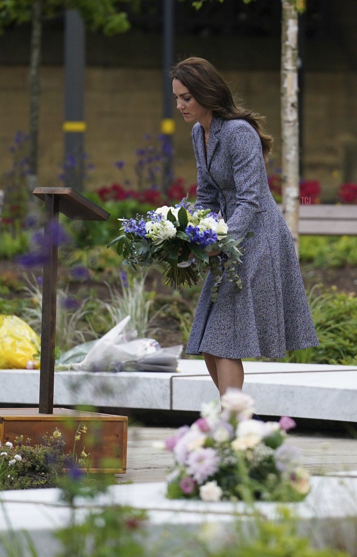 Catherine, Duchess Of Cambridge lays flowers as she and her husband Prince William, Duke of Cambridge attend the launch of the Glade of Light Memorial garden, outside Manchester Cathedral on May 10, 2022 in Manchester, England