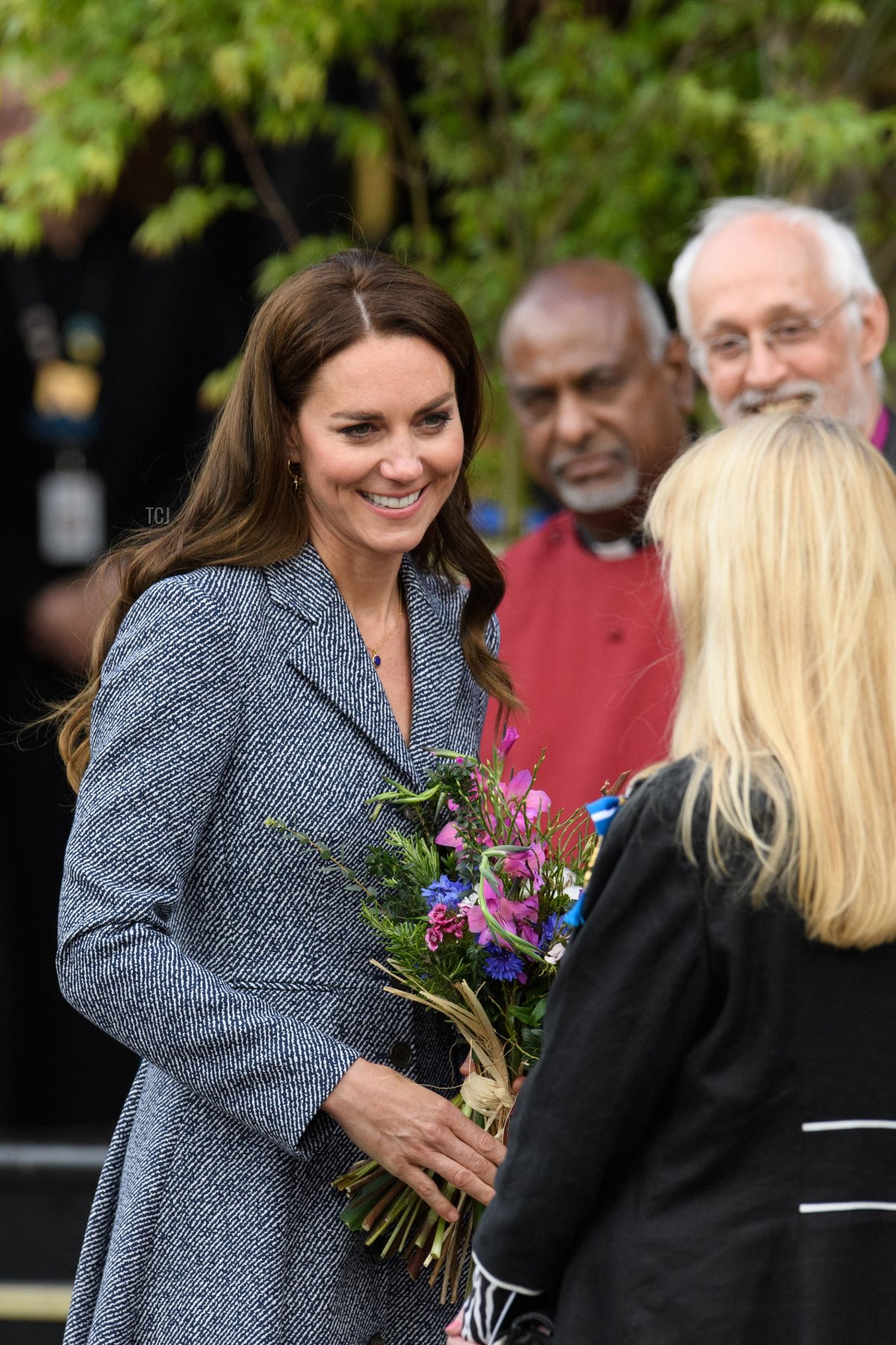 Britain's Catherine, Duchess of Cambridge (L) speaks with dignitaries as she departs Manchester Cathedral after attending the official opening of the Glade of Light memorial in Manchester, north-west England on May 10, 2022