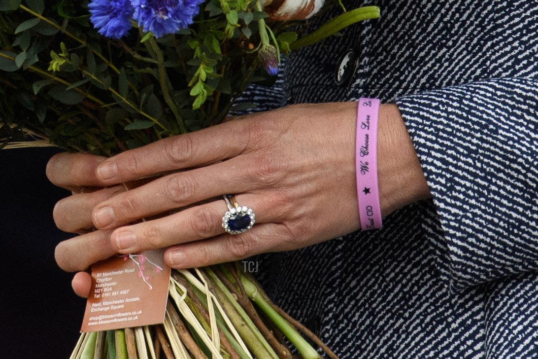 Britain's Catherine, Duchess of Cambridge holds a posy of flowers as she leaves after attending the official opening of the Glade of Light memorial in Manchester, north-west England on May 10, 2022