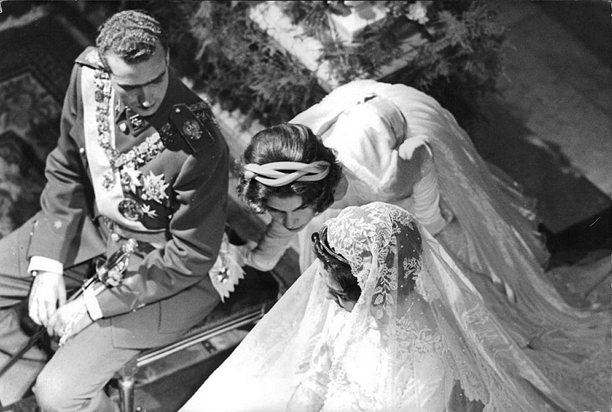 A photo of Prince Juan Carlos of Spain and Princess Sophia of Greece and Denmark sitting in their wedding ceremony rite