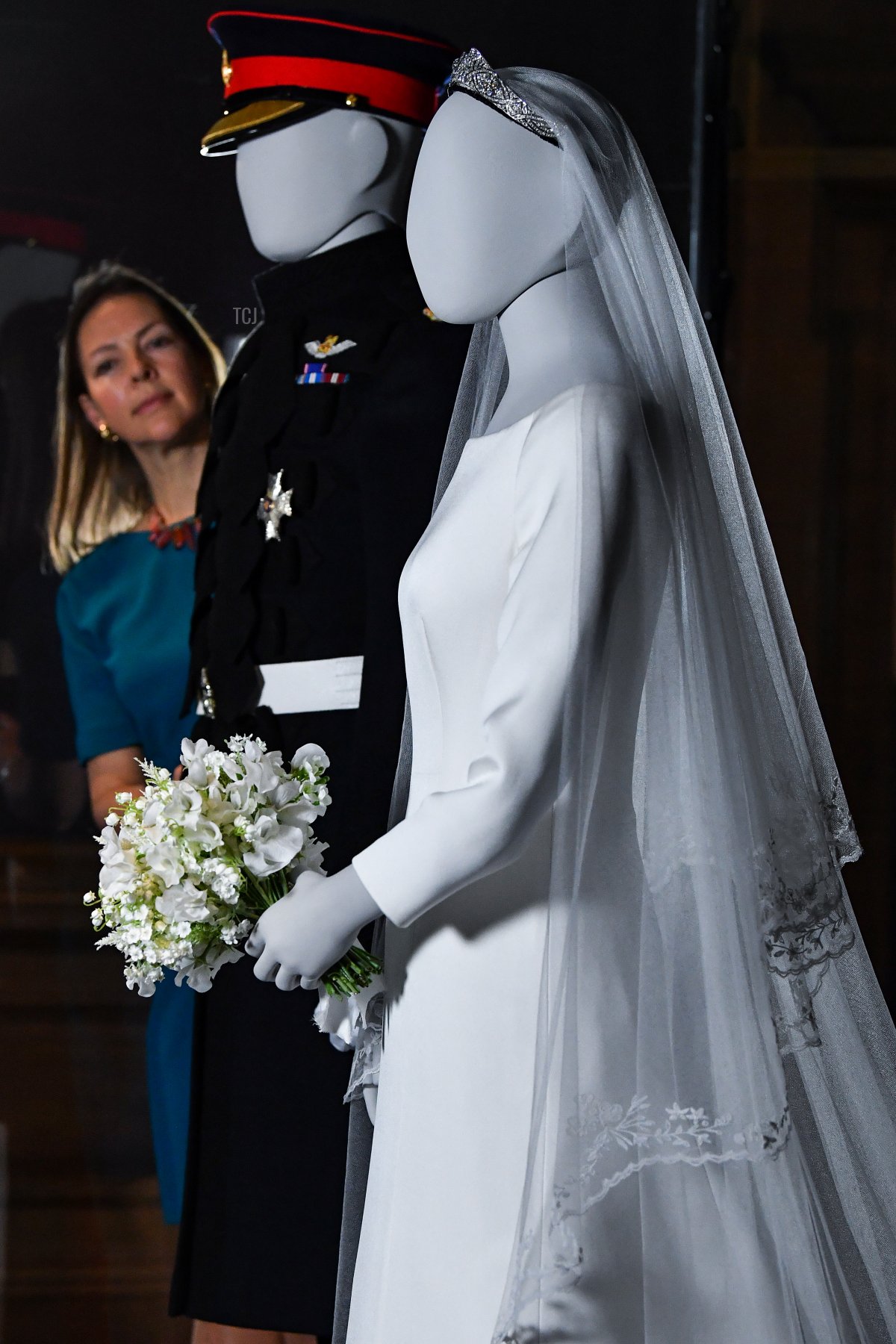 Senior Curator Caroline de Guitaut views the wedding outfits of the Duke and Duchess of Sussex, as they go on display at the Palace of Holyroodhouse for a special exhibition, 'A Royal Wedding: The Duke and Duchess of Sussex' which is being shown from June 14 to October 6, on June 13, 2019 in Edinburgh, Scotland