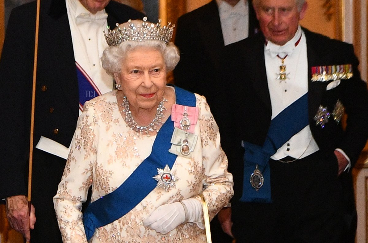 Queen Elizabeth II and Prince Charles, Prince of Wales greet guests at an evening reception for members of the Diplomatic Corps at Buckingham Palace on December 04, 2018 in London, England