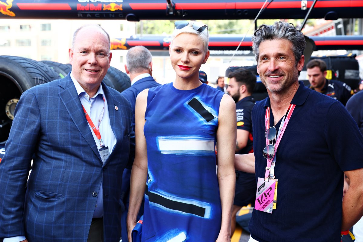 Prince Albert of Monaco Princess Charlene of Monaco and Patrick Dempsey pose for a photo outside the Red Bull Racing garage prior to qualifying ahead of the F1 Grand Prix of Monaco at Circuit de Monaco on May 28, 2022 in Monte-Carlo, Monaco