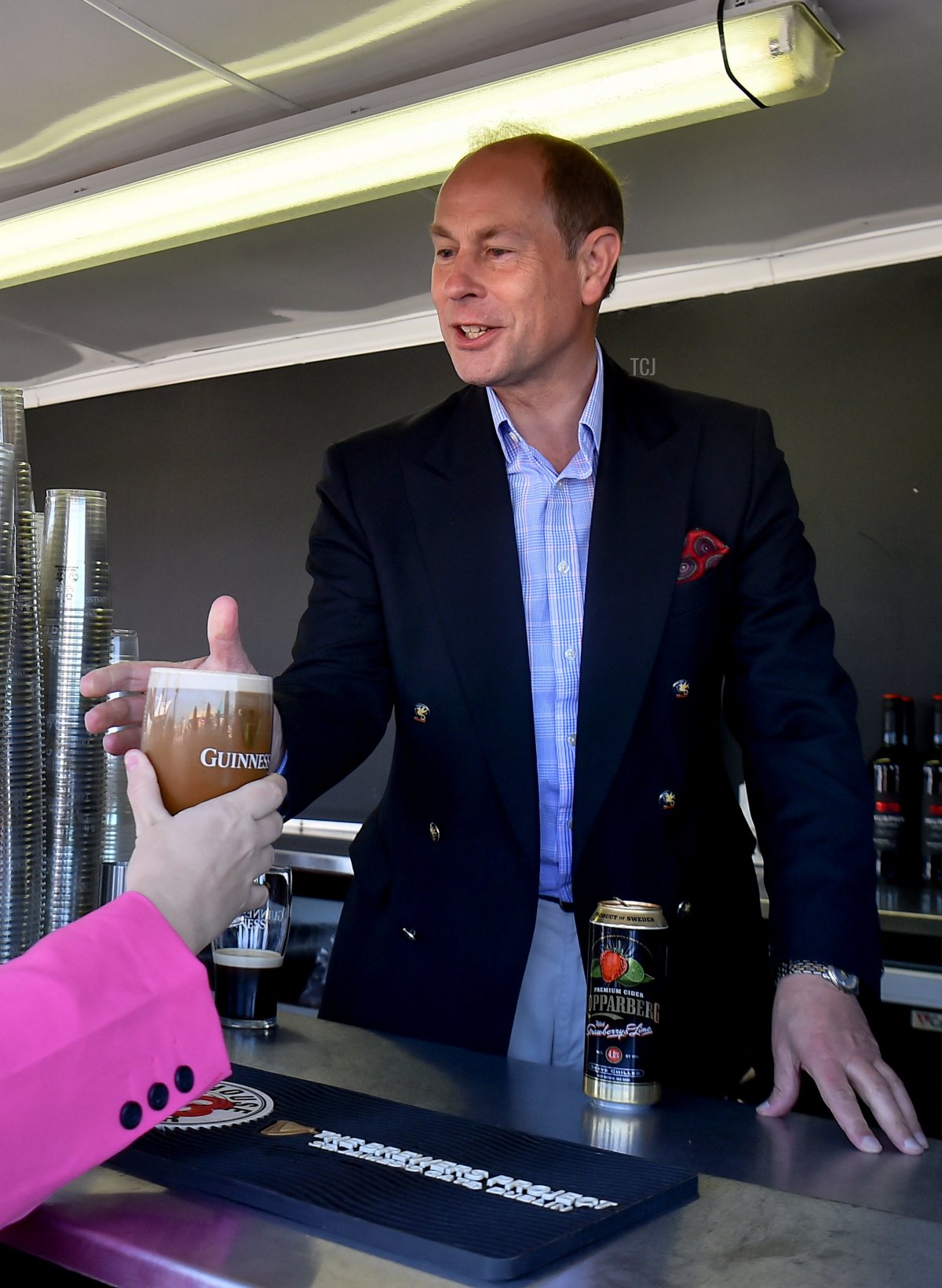 Prince Edward, Earl of Wessex, hands a beverage to a local as he attends a Platinum Jubilee celebration on June 4, 2022 in Bangor, United Kingdom