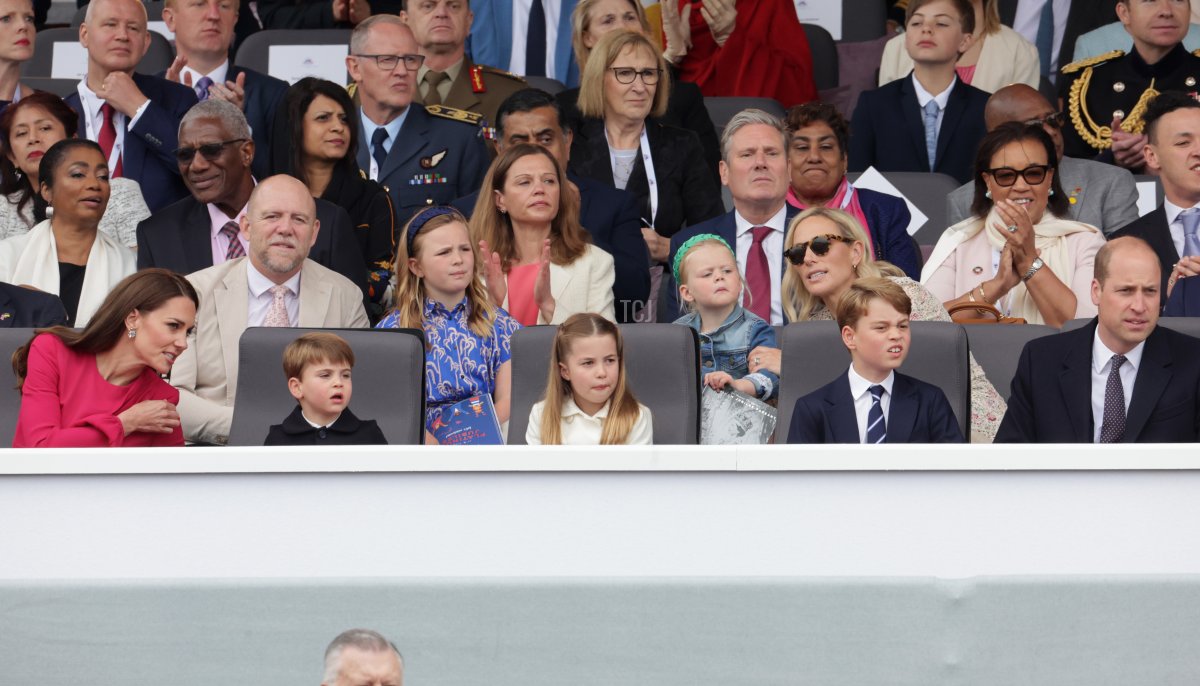 Mike Tindall, Mia Tindall, Victoria Starmer, Lena Tindall, Zara Tindall, (front row) Catherine, Duchess of Cambridge, Prince Louis of Cambridge and Prince William, Duke of Cambridge watch the Platinum Pageant on June 05, 2022 in London, England