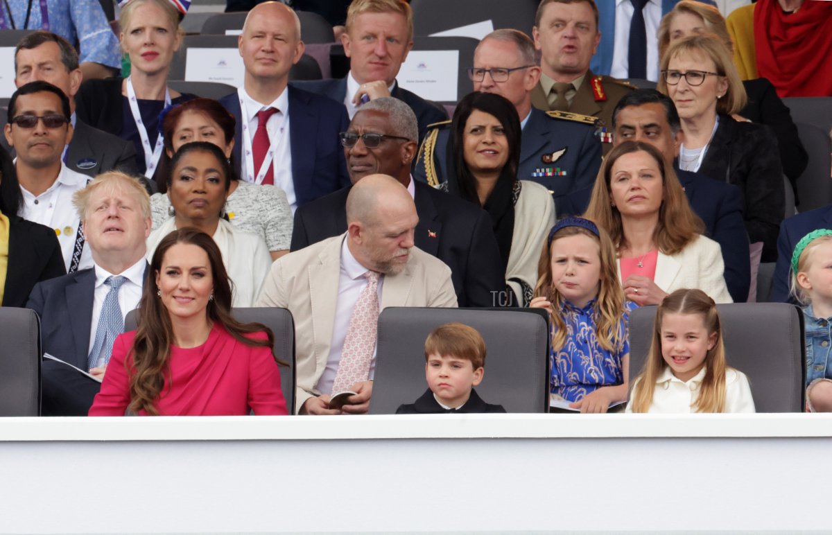 Prime Minister Boris Johnson, Mike Tindall Victoria Starmer, (front row) Catherine, Duchess of Cambridge, Prince Louis of Cambridge, and Princess Charlotte of Cambridge watch the Platinum Pageant on June 05, 2022 in London, England