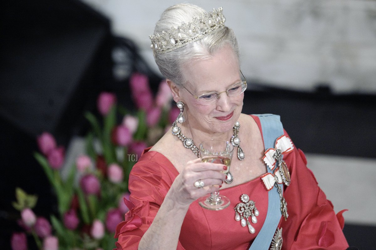 Danish Queen Margrethe raises her glass at Christiansborg Palace in central Copenhagen on April 13, 2010 during the official dinner party in celebration of the queens 70 years birthday