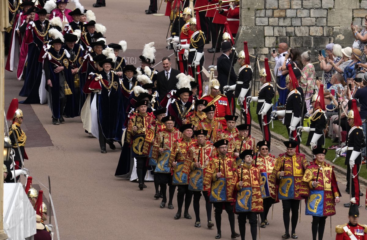 Former British Prime Minister Tony Blair, center, and former leader of the British House of Lords Baroness Amos, center left, walk in the procession to St George's Chapel for the Order of the Garter service at Windsor Castle, in Windsor, England, Monday, June 13, 2022
