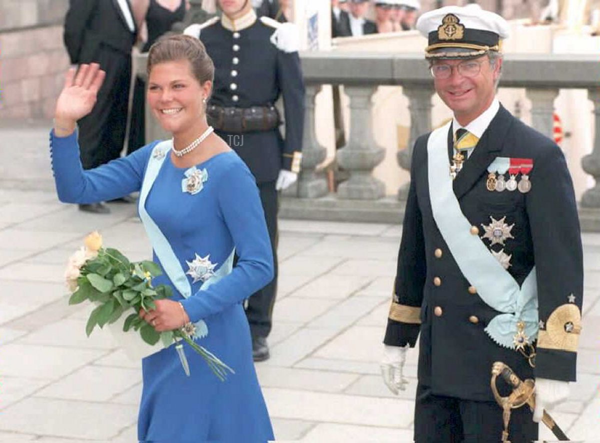 Swedish King Carl Gustav looks on as his daughter, crownprincess Victoria, flashes a smile towards waiting photographers 14 July, prior to a birthday reception at the Royal Castle in Stockholm this morning to celebrate her 18th birthday