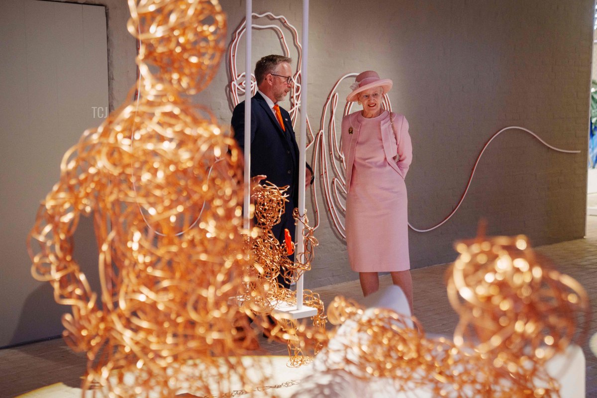 Danish Queen Margrethe (R) and museum director Claus Kjeld Jensen visit the exhibition during the inauguratio of the new Danish refugee museum FLUGT (escape) in Oksboel, Denmark, on June 25, 2022