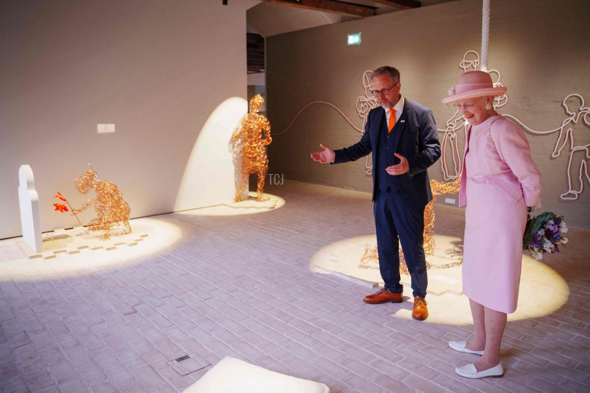 Danish Queen Margrethe (R) and museum director Claus Kjeld Jensen visit the exhibition during the inauguratio of the new Danish refugee museum FLUGT (escape) in Oksboel, Denmark, on June 25, 2022