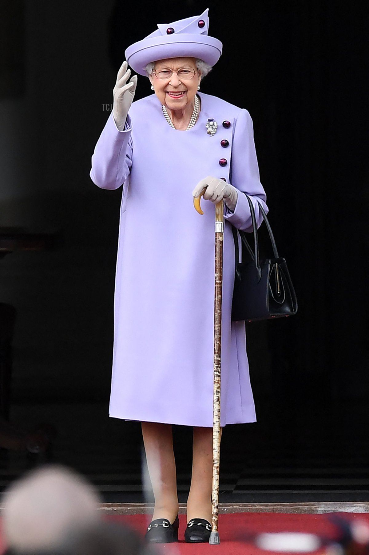 Britain's Queen Elizabeth II waves as she attends an Armed Forces Act of Loyalty Parade at the Palace of Holyroodhouse in Edinburgh, Scotland, on June 28, 2022
