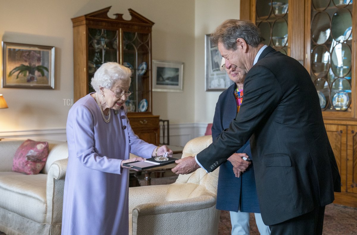 Queen Elizabeth II presents Her Majesty's Medal for Music for the year 2021 to John Wallace CBE at the Palace of Holyroodhouse, Edinburgh on June 28, 2022