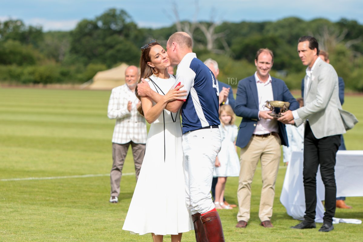 Prince William, Duke of Cambridge and Catherine, Duchess of Cambridge embrace during the Royal Charity Polo Cup 2022 at Guards Polo Club on July 06, 2022 in Egham, England