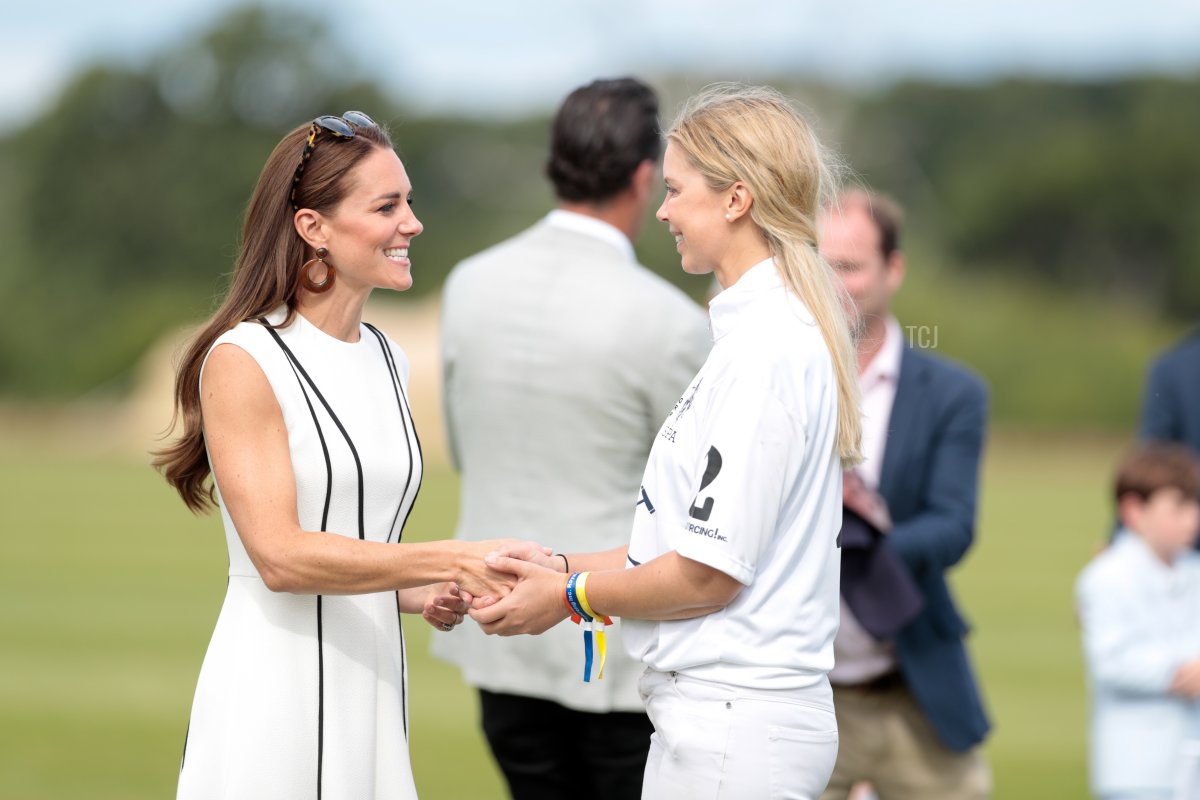 Catherine, Duchess of Cambridge shakes a players hand during the Royal Charity Polo Cup 2022 at Guards Polo Club on July 06, 2022 in Egham, England