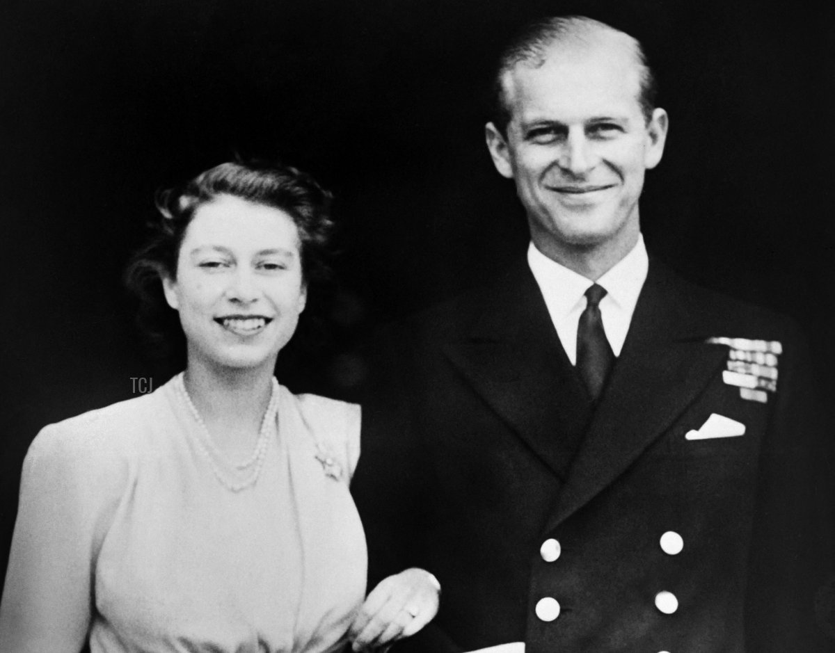Princess Elizabeth and Prince Philip of Greece pose on the day of their engagement, in July 1947, outside Buckingham Palace in London