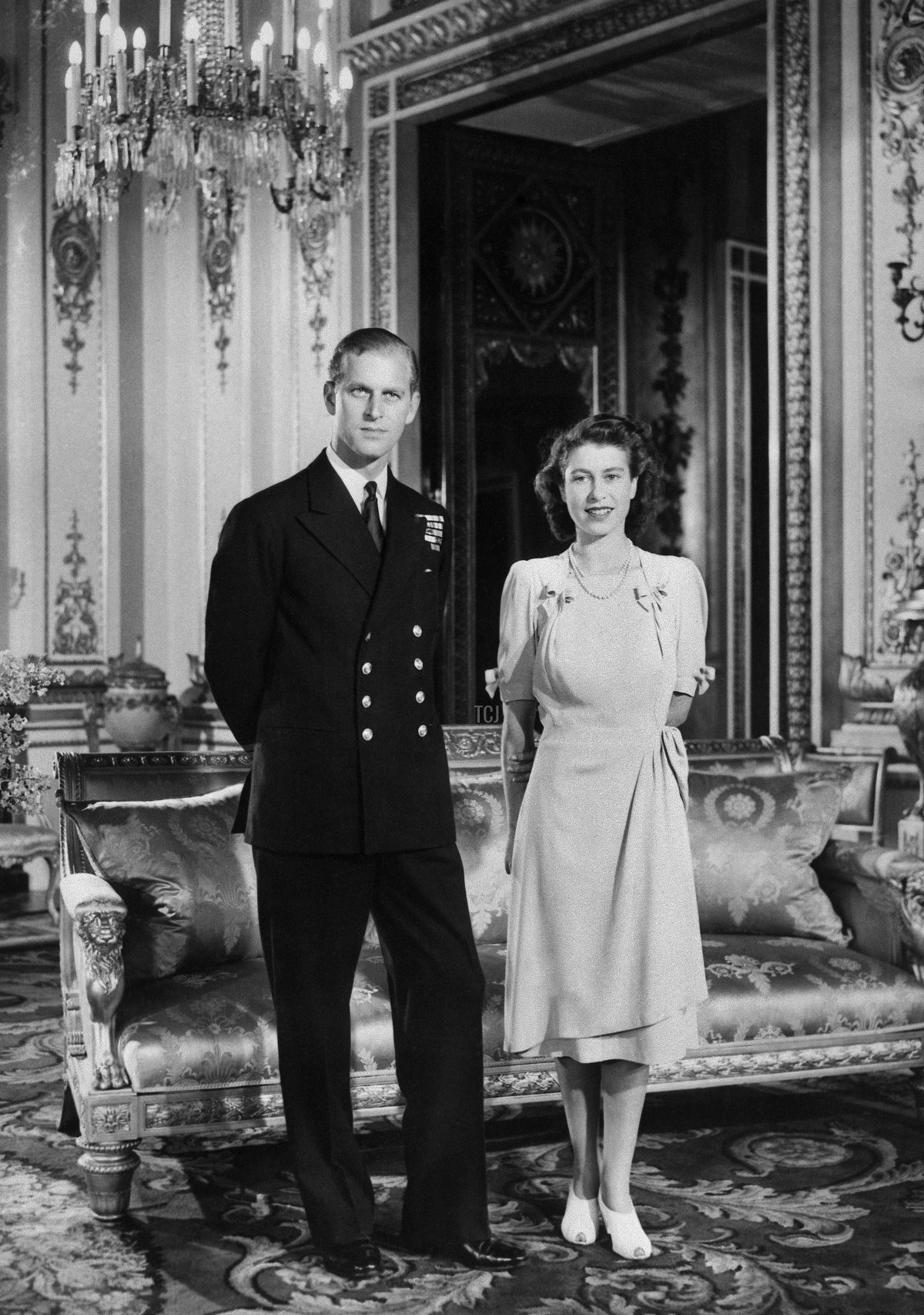 Princess Elizabeth (future Queen Elizabeth II) and her Fiance Philip Mountbatten (the future Duke of Edinburgh) pose in Buckingham Palace in London on July 9, 1947 in London, the day their engagement was officially announced