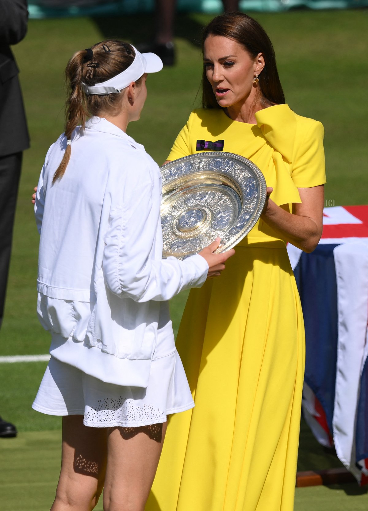 Britain's Catherine, Duchess of Cambridge gives the Venus Rosewater Dish trophy to Kazakhstan's Elena Rybakina during the podium ceremony after winning the women's singles final tennis match against Tunisia's Ons Jabeur on the thirteenth day of the 2022 Wimbledon Championships at The All England Tennis Club in Wimbledon, southwest London, on July 9, 2022