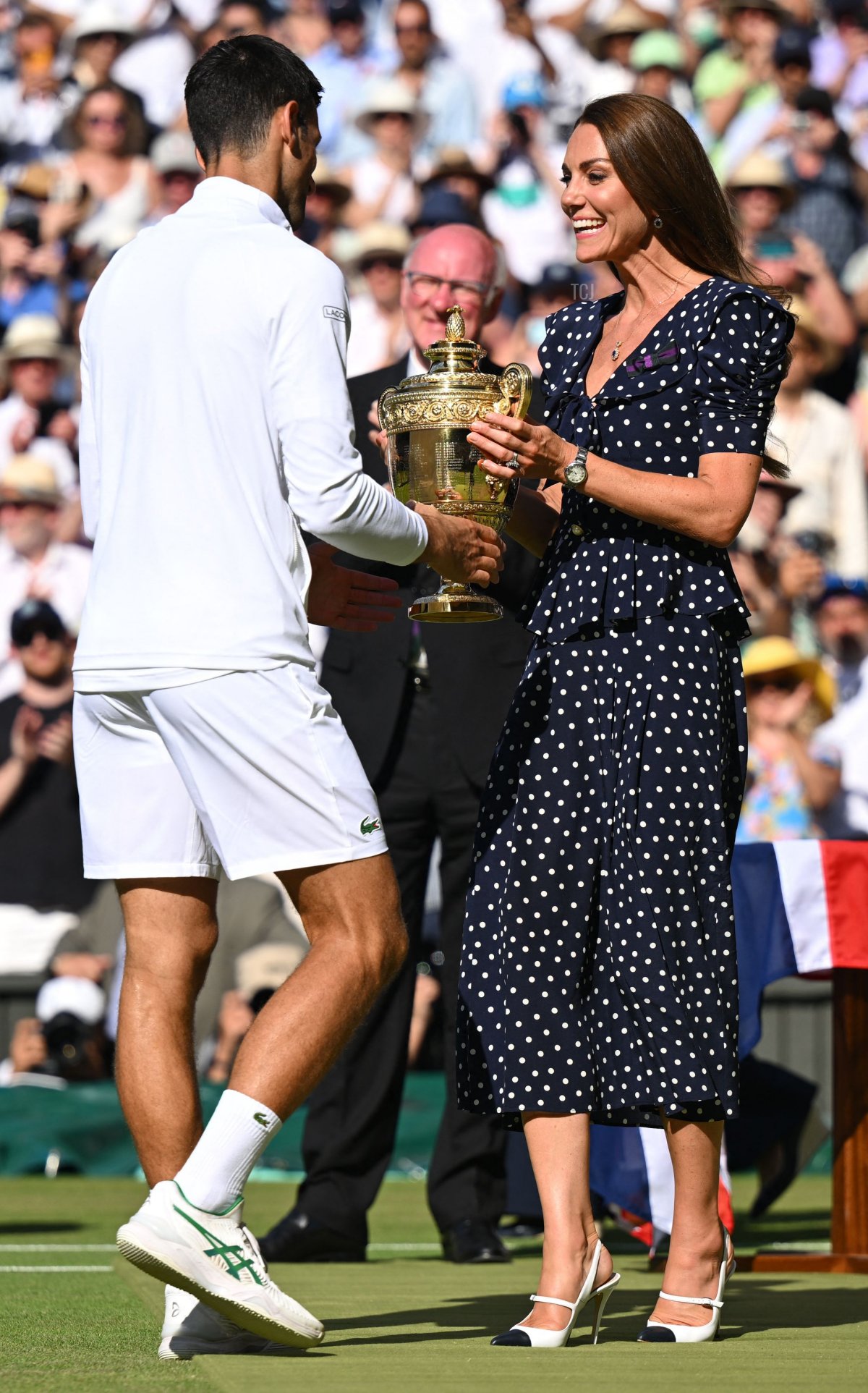 Britain's Catherine, Duchess of Cambridge (R), hands the winner's trophy to Serbia's Novak Djokovic after defeating Australia's Nick Kyrgios during the men's singles final tennis match on the fourteenth day of the 2022 Wimbledon Championships at The All England Tennis Club in Wimbledon, southwest London, on July 10, 2022