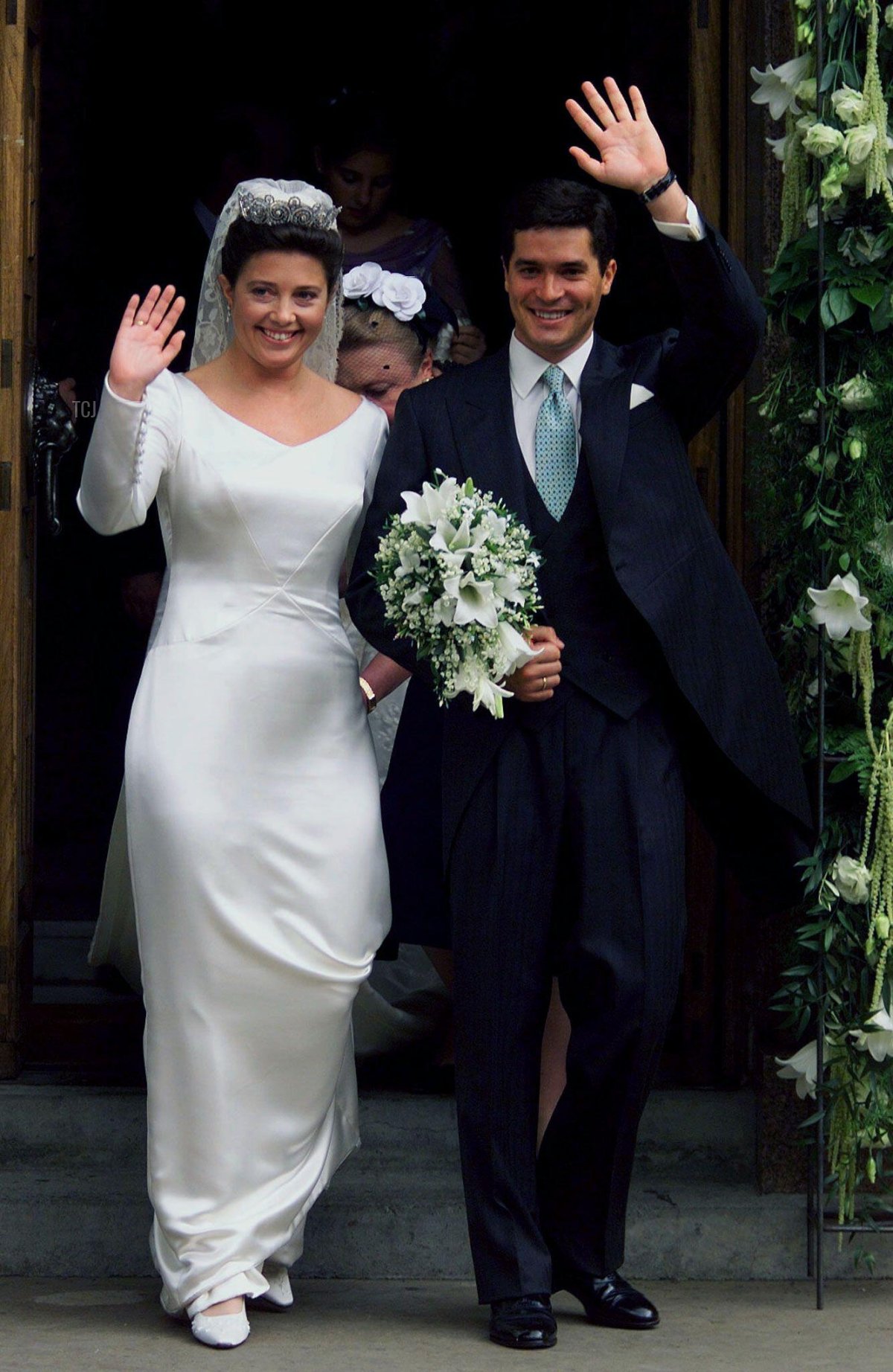 Princess Alexia of Greece and her new husband Carlos Morales Quintana of Spain wave following their wedding July 9
