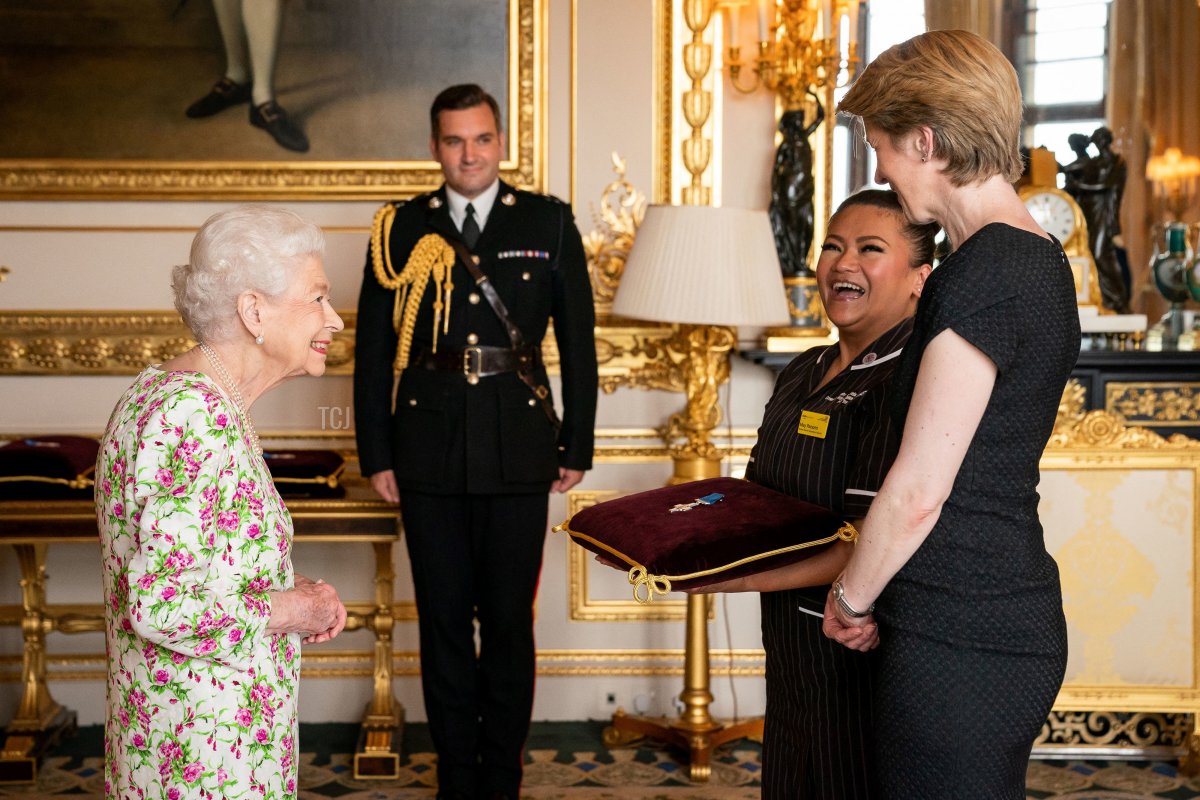 Britain's Queen Elizabeth II presents the George Cross to NHS England CEO Amanda Pritchard (R), and May Parsons, Modern Matron at University Hospital Coventry and Warkwickshire, representatives of Britain's National Health Service (NHS), during an Audience at Windsor Castle, west of London on July 12, 2022