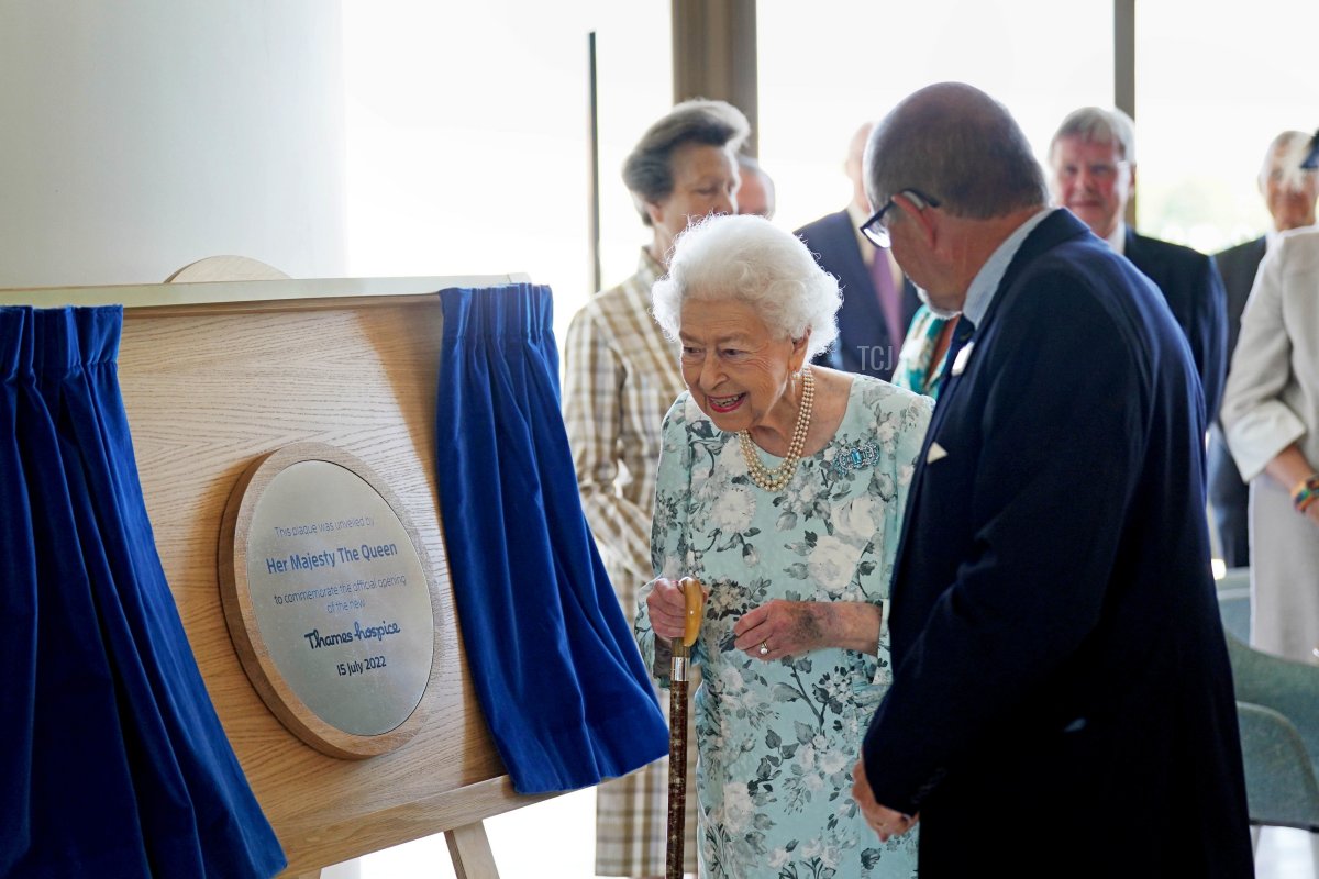 Queen Elizabeth II stands with Jonathan Jones, Chair of Trustees, after unveiling a plaque during a visit to officially open the new building at Thames Hospice on July 15, 2022 in Maidenhead, England