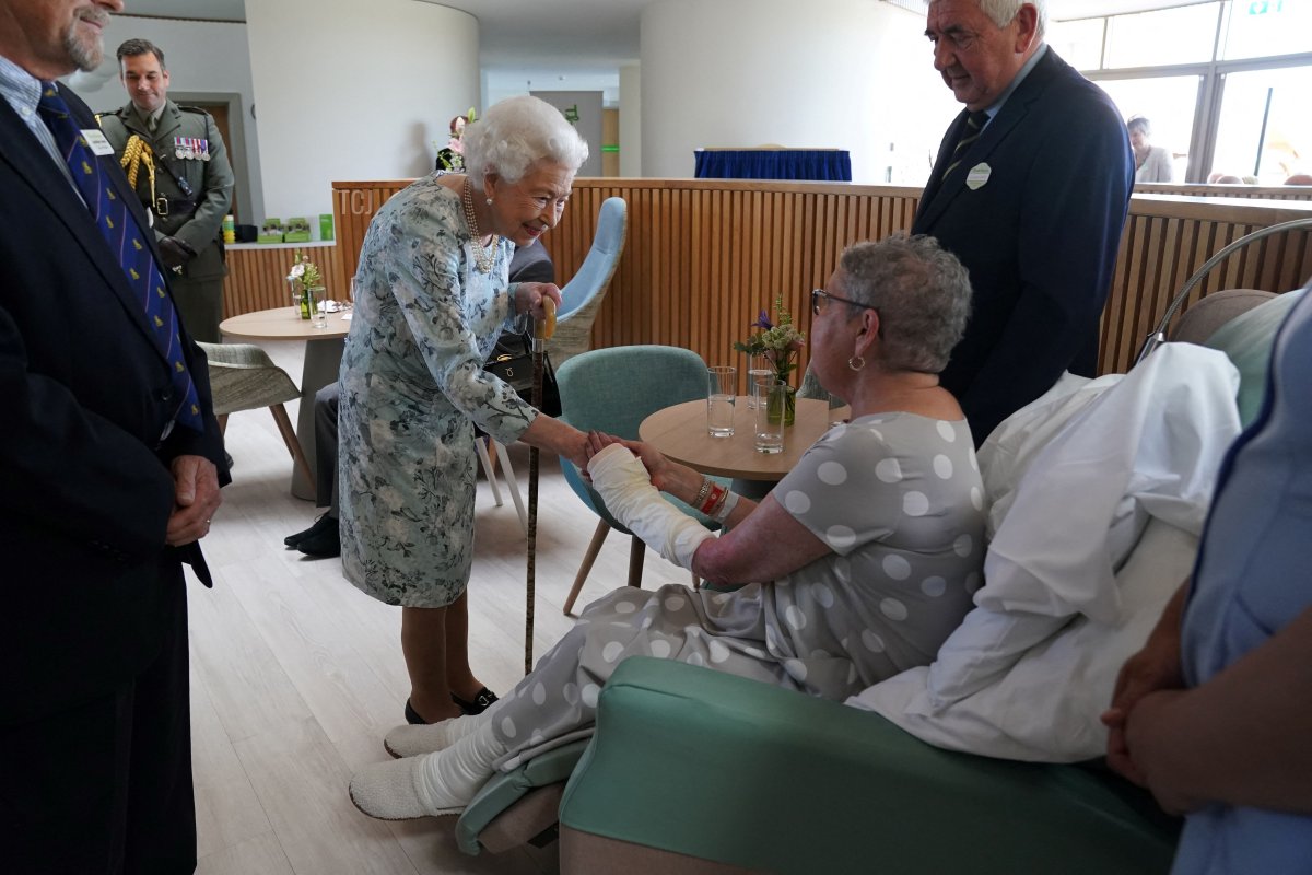 Britain's Queen Elizabeth II shakes hands with patient Pat White during a visit to officially open the new building of Thames Hospice in Maidenhead, Berkshire, on July 15, 2022