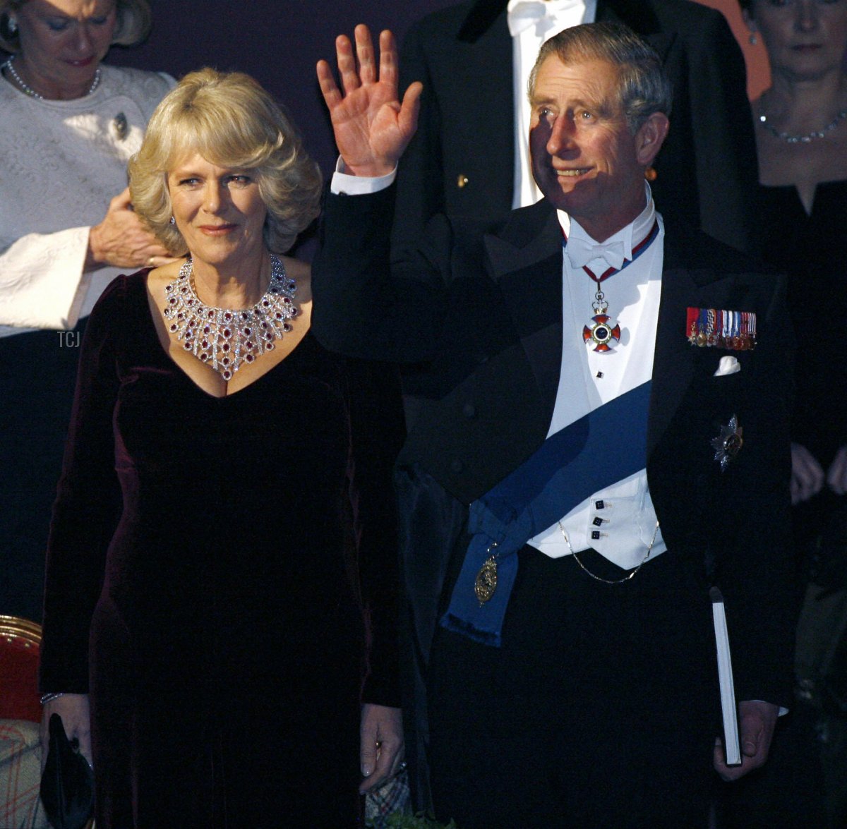 Britain's Prince Charles and his wife Camilla Parker-Bowles are presentes with a gift at the Philadelphia Academy of Music, 27 January 2007