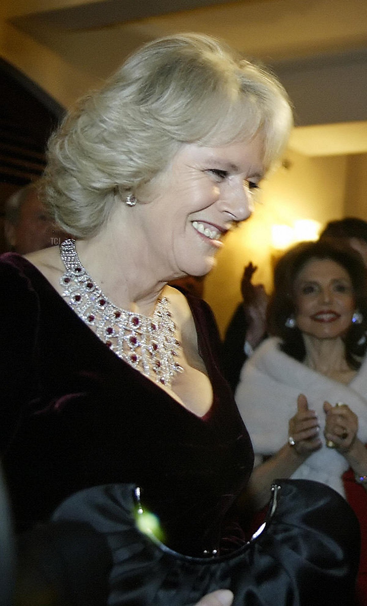 Britain's Prince Charles and his wife Camilla Parker-Bowles are presentes with a gift at the Philadelphia Academy of Music, 27 January 2007
