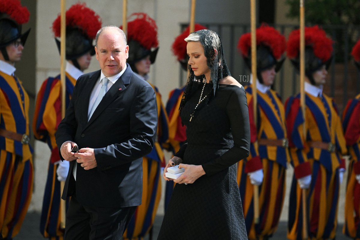 Monaco's Prince Alberto II and Princess Charlene walk along the San Damaso courtyard as they leave following a private audience with Pope Francis, at the Vatican on July 20, 2022