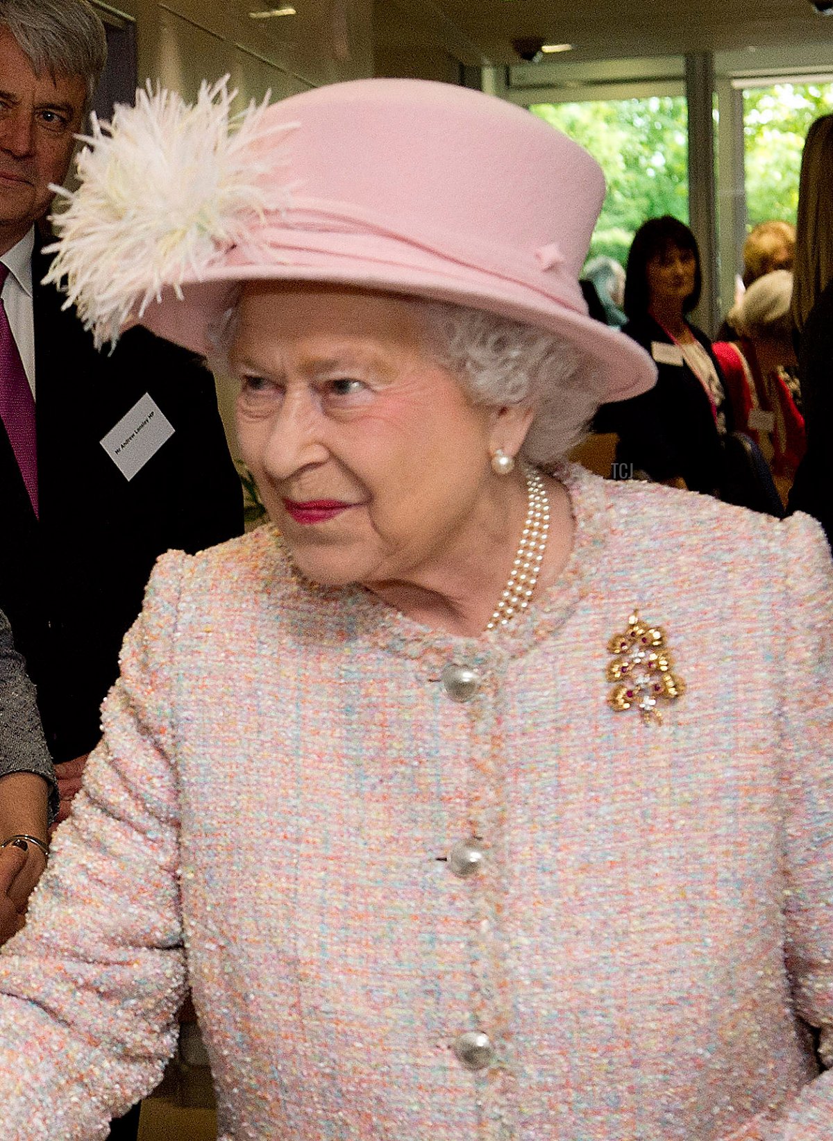 Queen Elizabeth II is greeted by Jeffrey Archer (L) and his wife Mary Archer (2nd L) during her visit to Rosie Maternity Hospital on May 23, 2013 in Cambridge, England