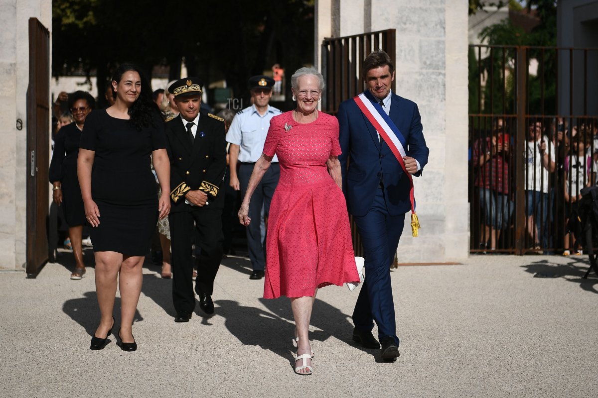 Queen Margrethe II of Denmark (2nd R), flanked by the mayor of Cahors Jean-marc Vayssouze-Faure (R) and director of the Cahors museum Rachel Amalric (L), arrives at the Henri Martin museum for the inauguration of her works, in Cahors, southern France, on August 17, 2022