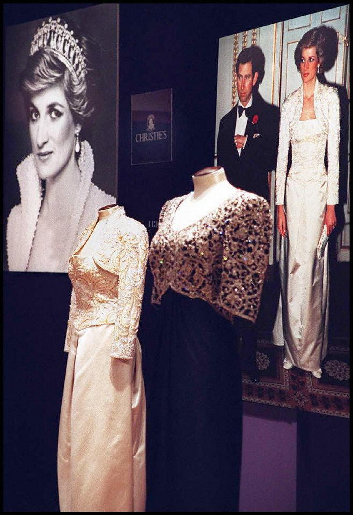 Dresses from the collection of the Princess of Wales are displayed along with photographs showing the occasions they were worn 25 February at Christies auction house in New York