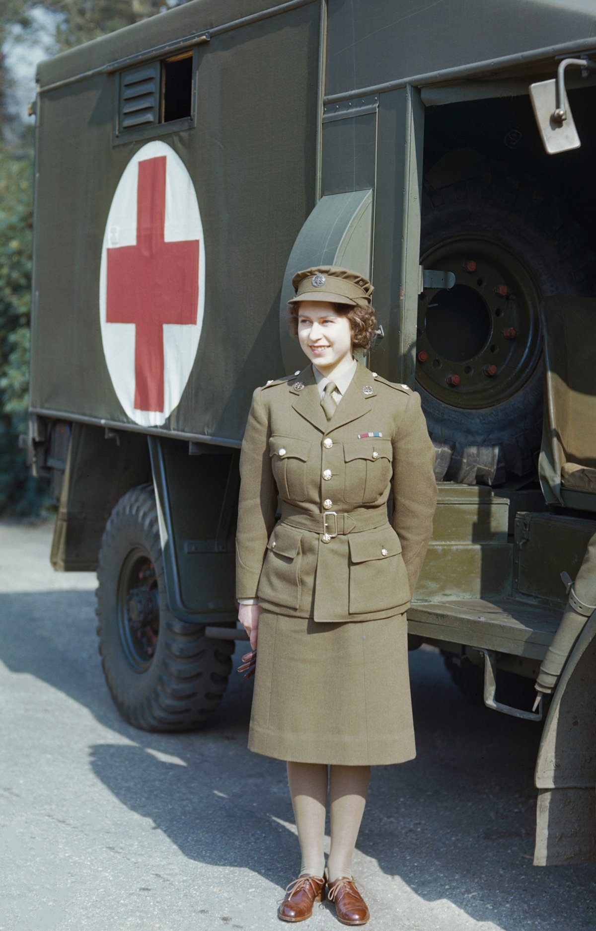 Princess Elizabeth, a 2nd Subaltern in the ATS standing in front of an ambulance, April 1945
